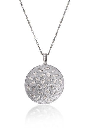 This large, radiant pendant is set with a stunning 28 white diamond baguettes. Richly textured to shimmer in the light, this piece is available in three color ways, oxidized silver, 18k gold and palladium.  0.773 tcw.