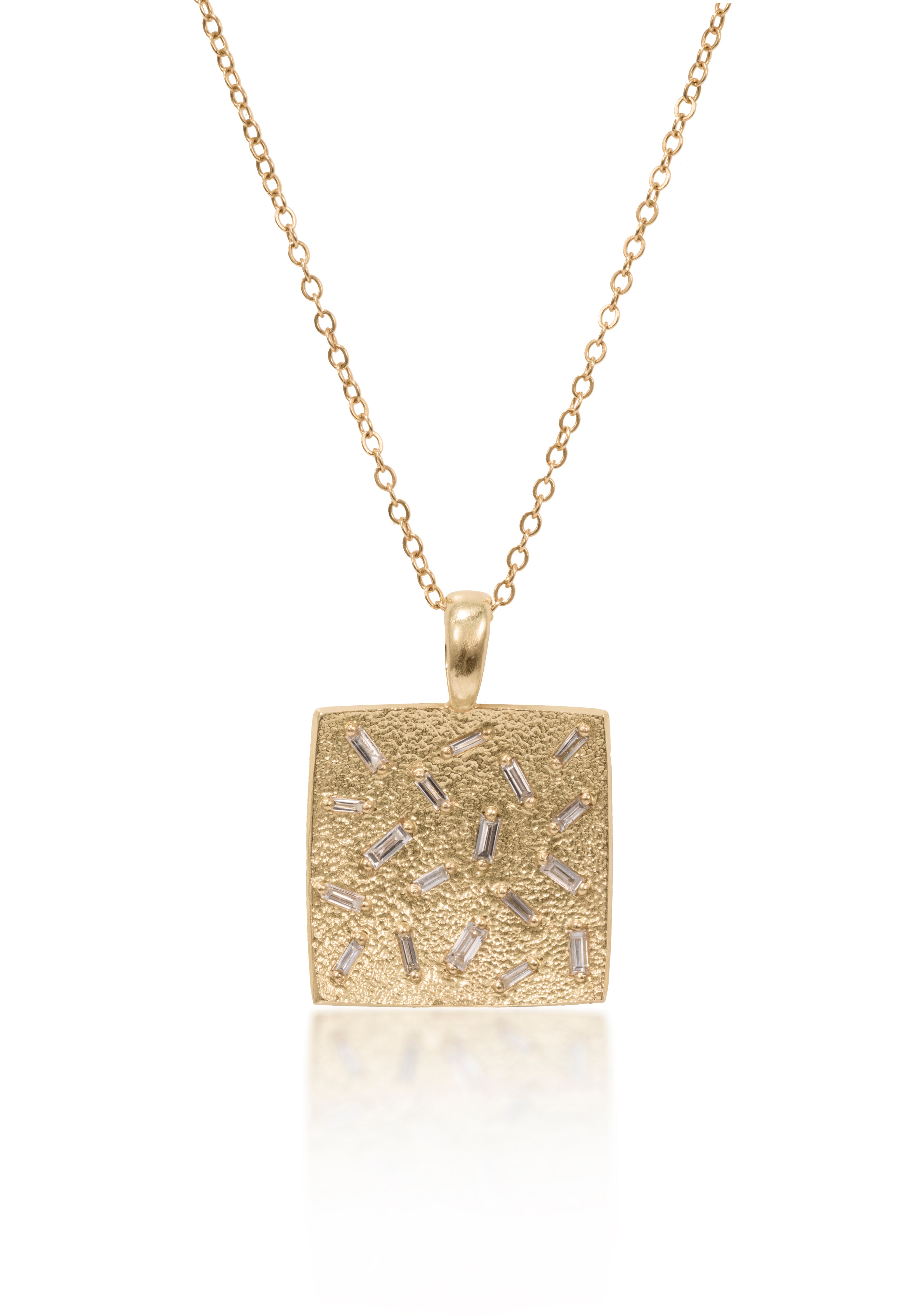 This medium size square pendant is set with 18 white diamond baguettes. Richly textured to shimmer in the light, this piece is available in three color ways, oxidized silver, 18k gold and palladium.  0.486 tcw.