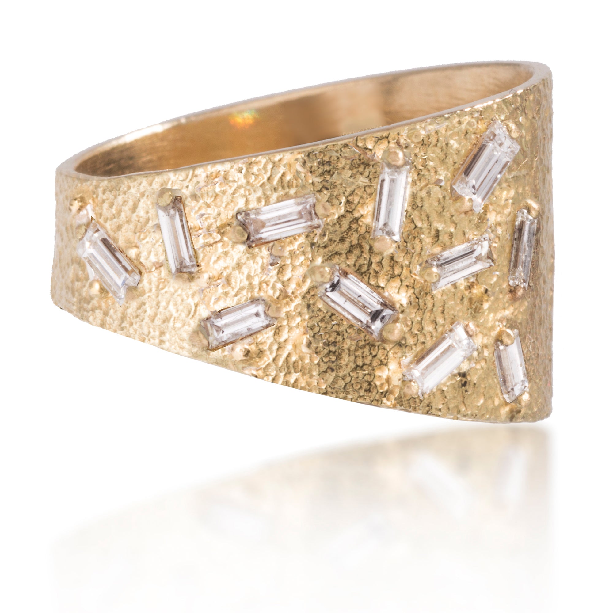 This tapered wedge style ring is set with 11 white diamond baguettes.  It is available in three richly textured color ways, oxidized silver, 18k gold and palladium. 0.36 tcw.
