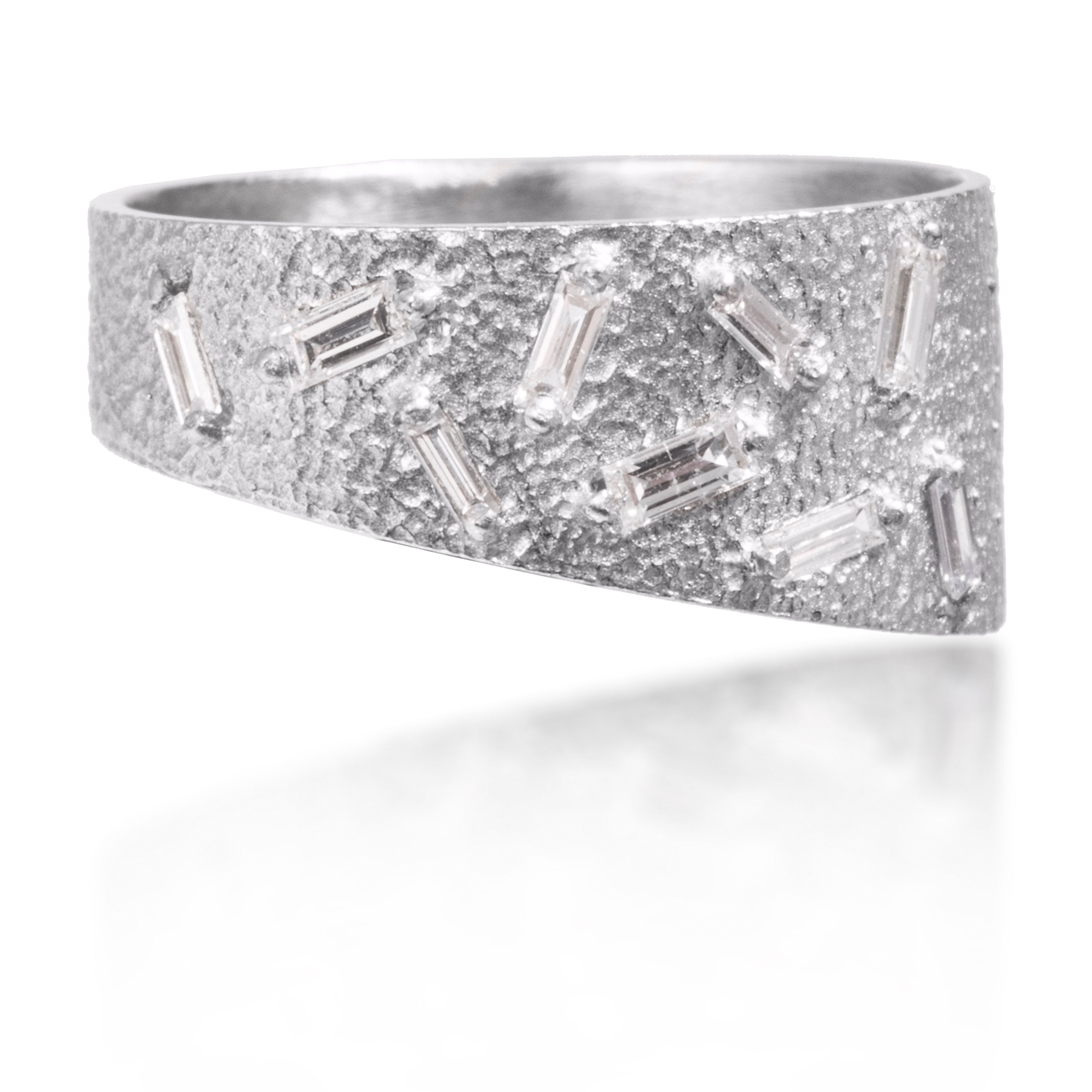 This stackable ring is set with 9 white diamond baguettes. It is available in four richly textured color ways, oxidized silver, 18k gold, palladium and platinum. 0.2798 tcw.