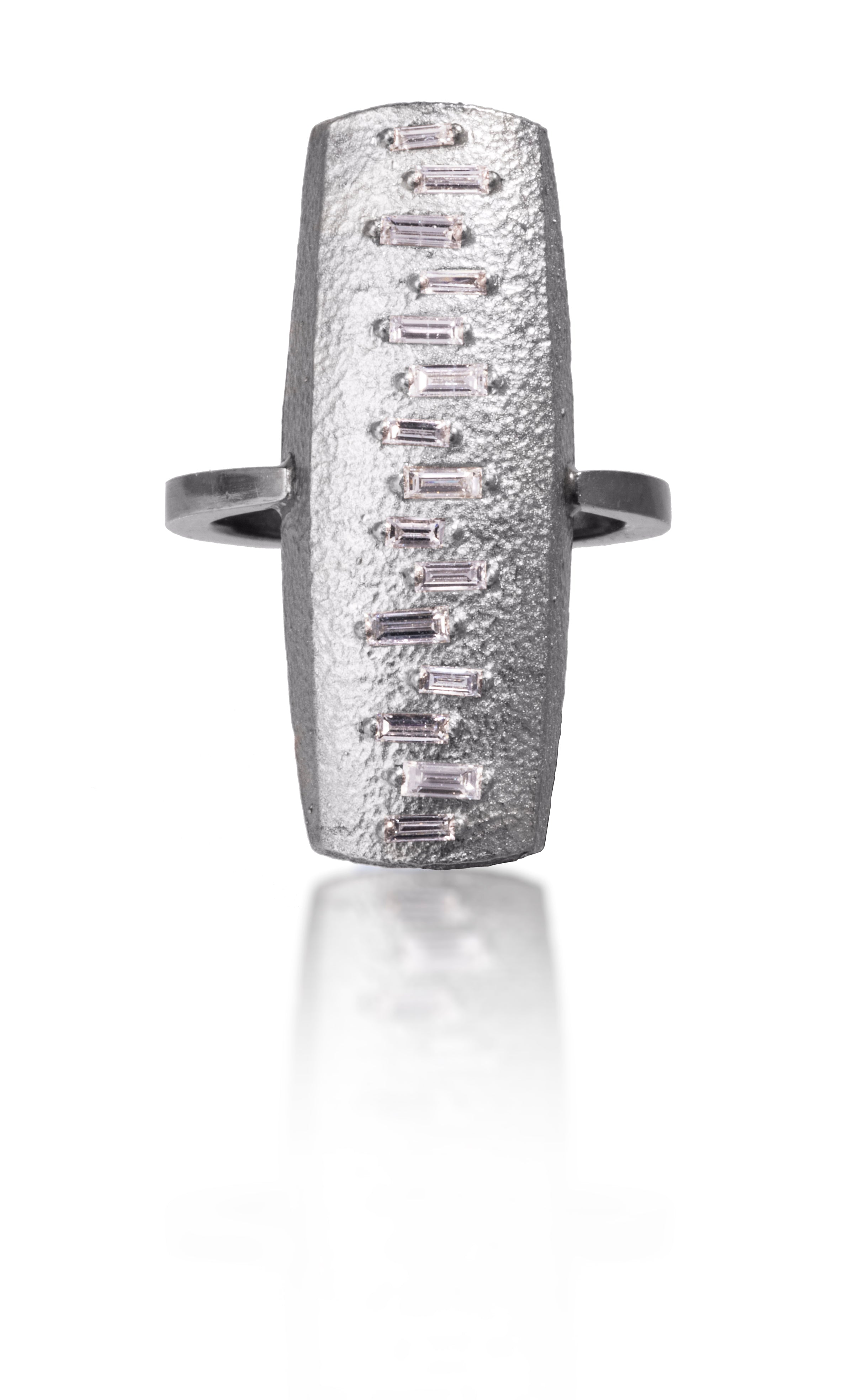 This large pendant ring is set with 15 white diamond baguettes. It is available in three richly textured color ways, oxidized silver, 18k gold, and palladium.  The graceful irregularity of the baguette angles catch the light in exciting ways when worn. 0.4713 tcw.