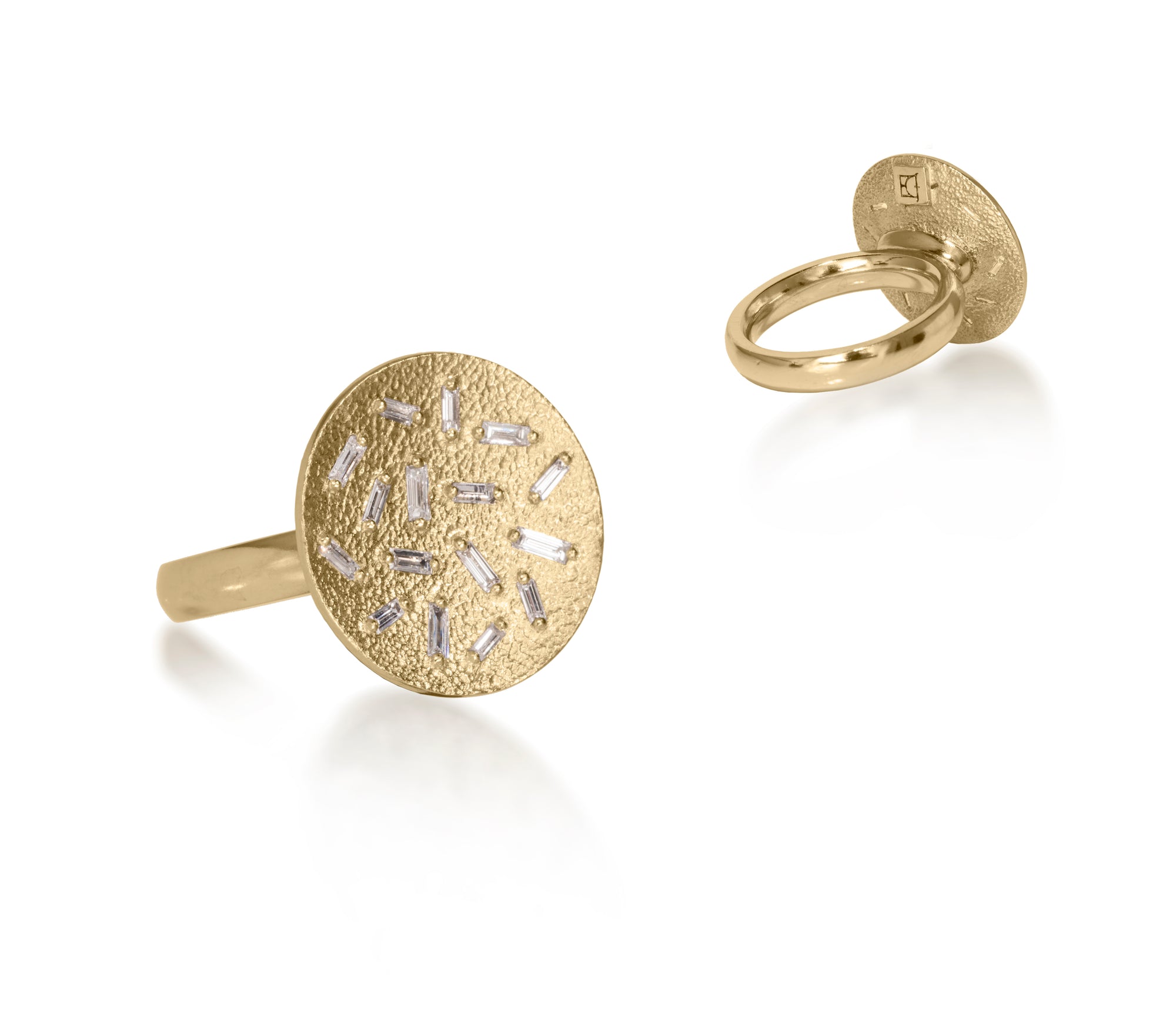 This medium circular pendant ring is set with 16 white diamond baguettes. It is available in three richly textured color ways, oxidized silver, 18k gold and palladium.  The random angles of the baguettes catch the light in exciting ways when worn. 0.435 tcw.