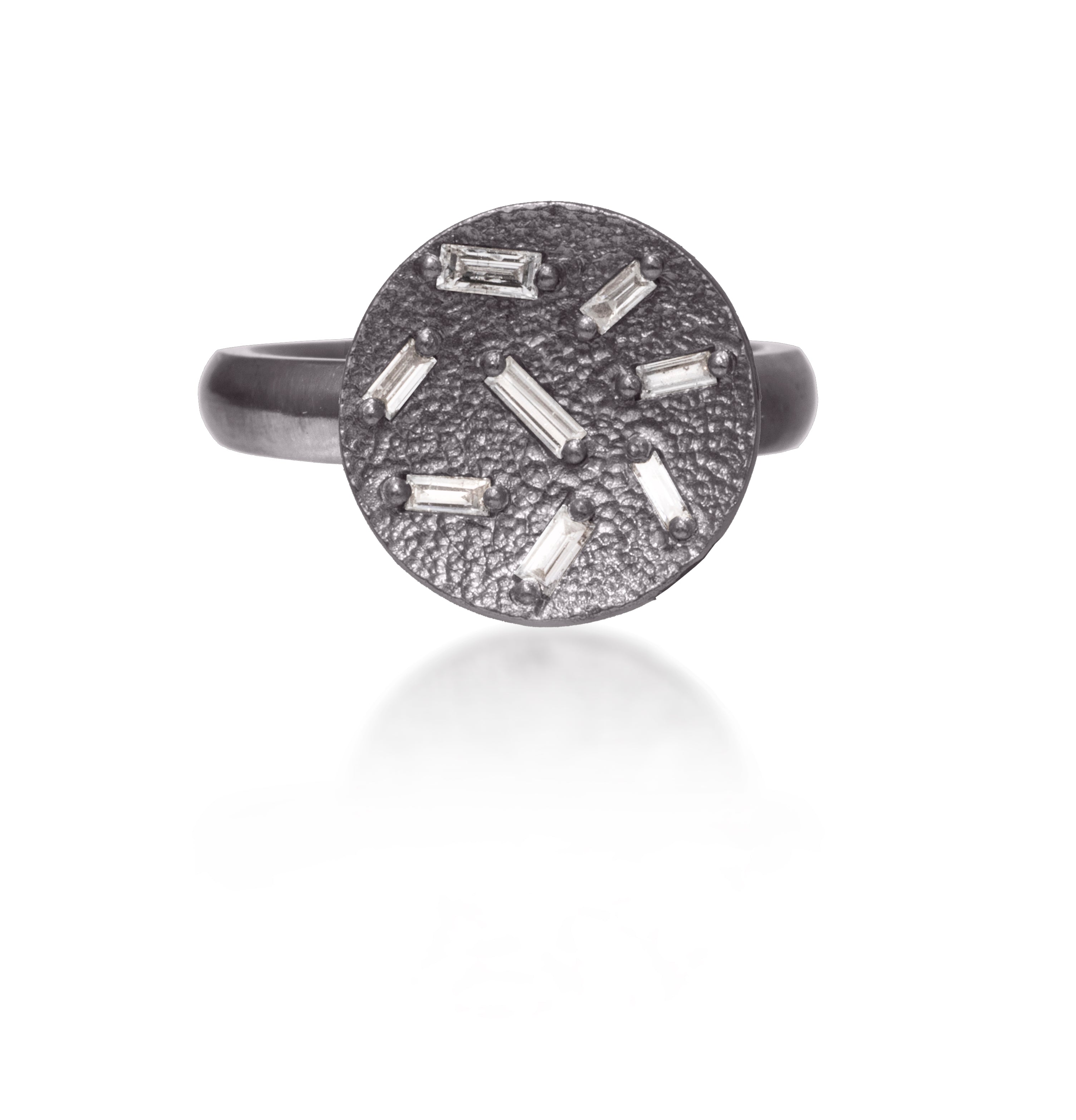 This small circular pendant ring is set with 8 white diamond baguettes. It is available in three richly textured color ways, oxidized silver, 18k gold and palladium.  The random angles of the baguettes catch the light in exciting ways when worn. 0.227 tcw.