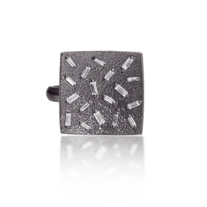 This medium square pendant ring in oxidized sterling silver is set with 18 white diamond baguettes. It is available in three richly textured color ways, oxidized silver, 18k gold, and palladium.  The random angles of the baguettes catch the light in exciting ways when worn. 0.486 tcw.