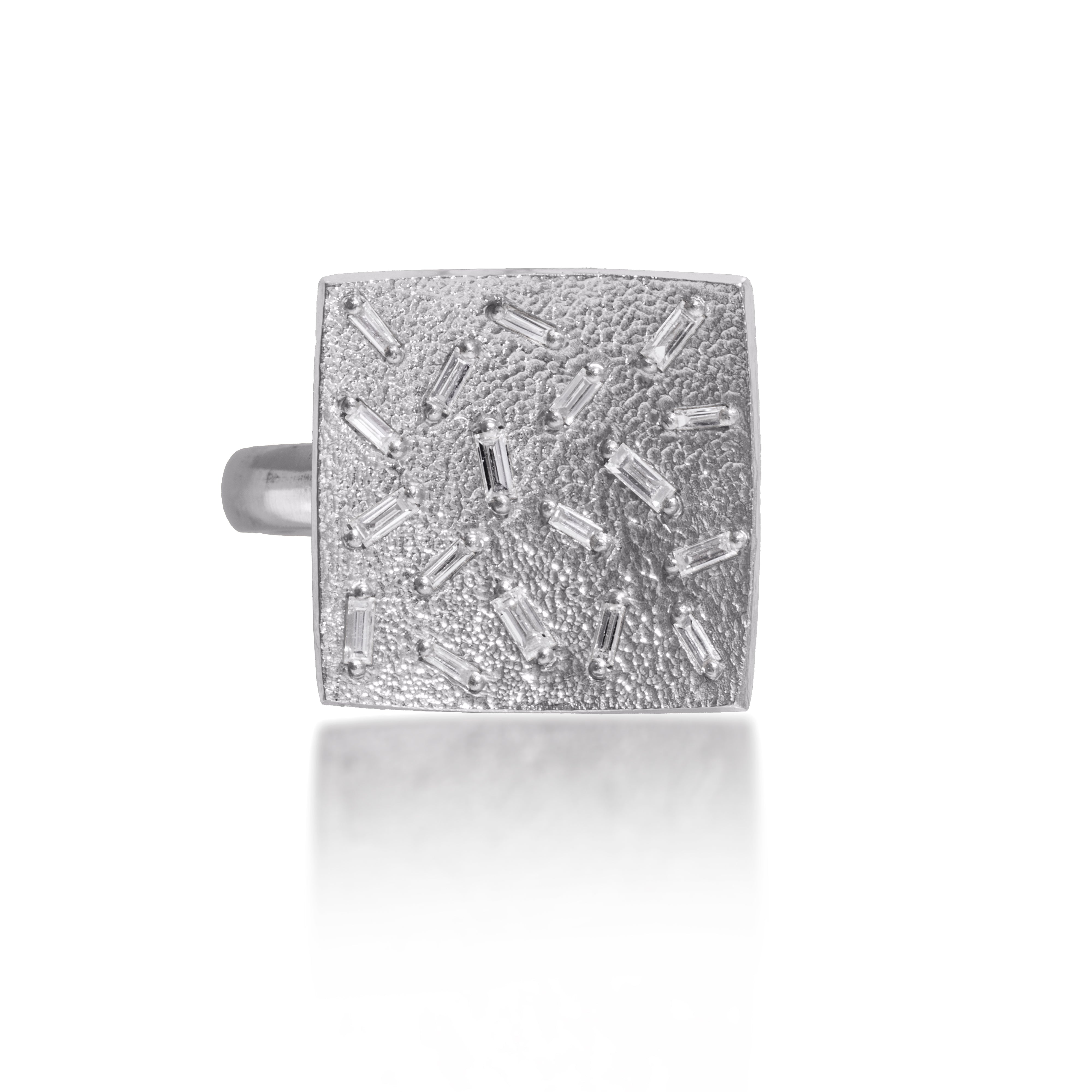 This medium square pendant ring in oxidized sterling silver is set with 18 white diamond baguettes. It is available in three richly textured color ways, oxidized silver, 18k gold, and palladium.  The random angles of the baguettes catch the light in exciting ways when worn. 0.486 tcw.