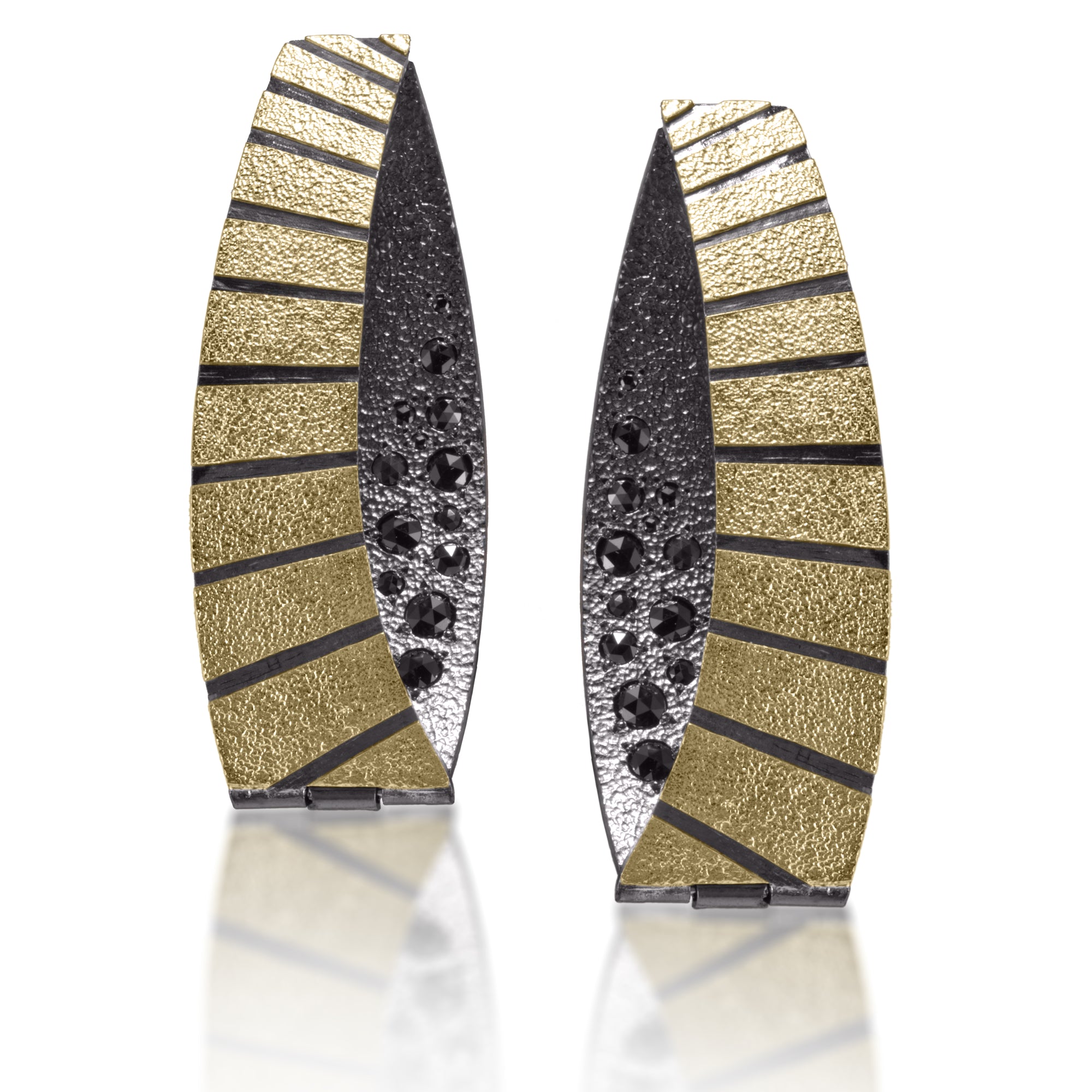 Energy, line and form combine to create Stripe Earring #4.  Made in 18k gold and oxidized sterling silver, the design features graduated, radial stripes.  Bead set rose cut, black diamonds 0.7782 tcw., add a secret shimmer to contrasting areas of oxidized sterling. Hinged huggie style earring with 18k gold posts and a dramatically curved form.  Hand fabricated, stipple textured and engraved mixed metals.