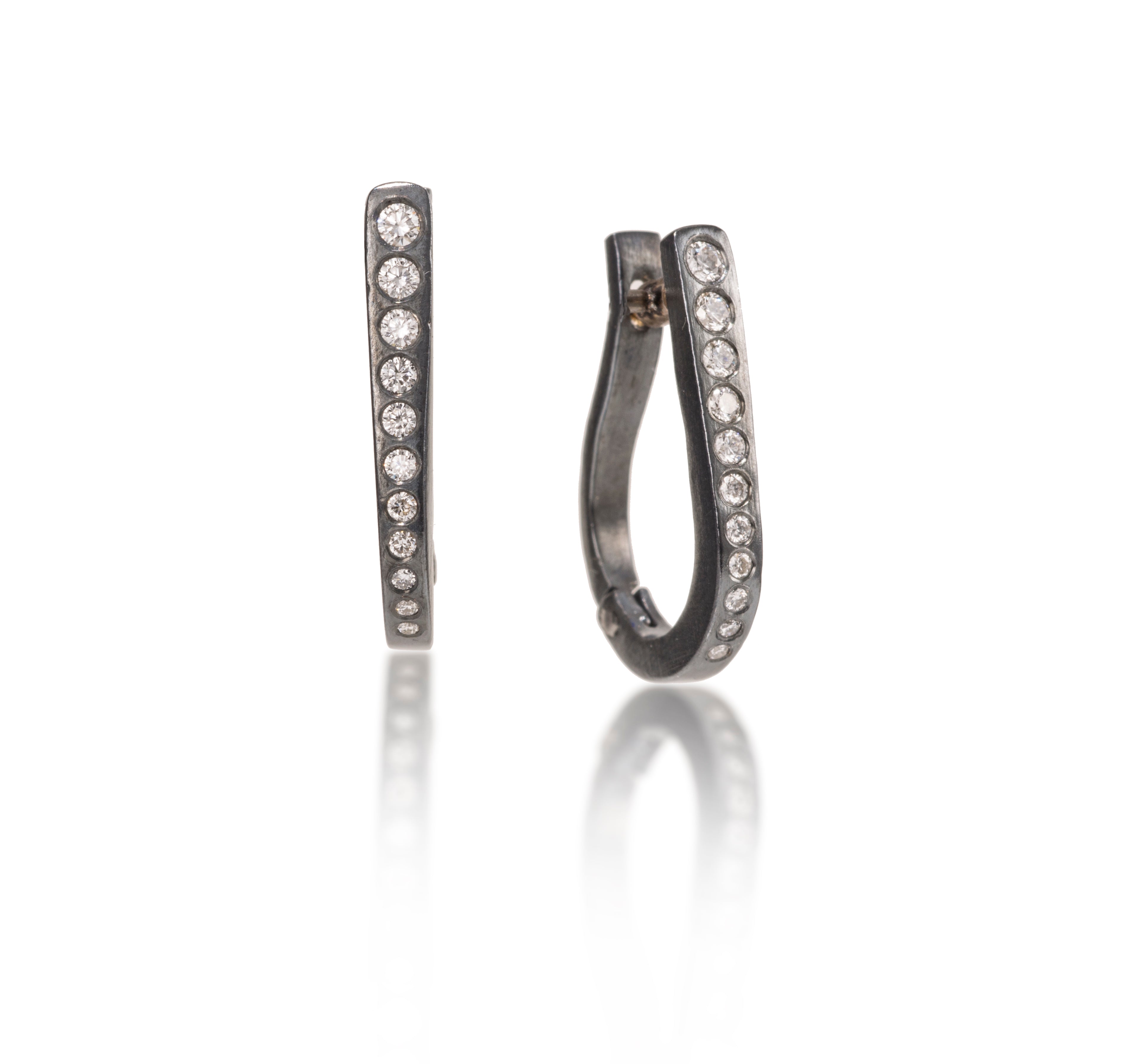 These simple, but elegant horseshoe shaped hoops are great on their own or accented with gem as a drop earring.  They feature cascading white diamonds, 0.318 tcw., and a built in closure that snaps securely closed.  Available in four color ways, oxidized silver, 18k gold, palladium or platinum.